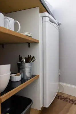 a white refrigerator freezer sitting inside of a kitchen at The Neuk in Uphall