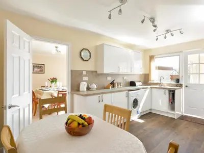 a kitchen with a table with a bowl of fruit on it at Westburn in Comrie