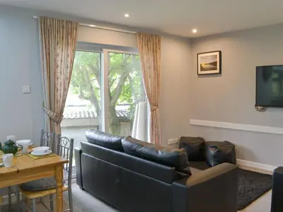 a living room with a couch and a table at Puffin - Kerrera in Lerags