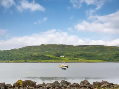 a boat in the middle of a large body of water at Puffin - Kerrera in Lerags