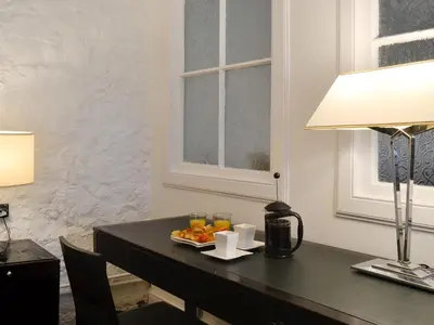 a desk with a plate of fruit and a lamp at The Calving Shed in Neilston