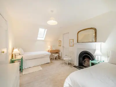 a bedroom with two beds and a fireplace at Inverglen Farm in Strachur