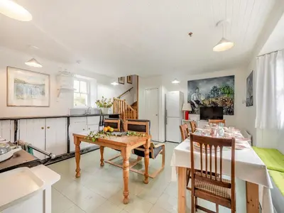 a kitchen and dining room with a table and chairs at Inverglen Farm in Strachur
