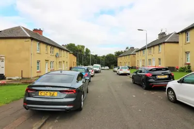 a row of cars parked on the side of a street at Signature - Shawburn House in Hamilton
