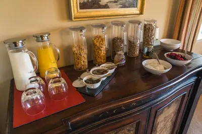 a table with many glass jars of food and drinks at Dunroamin in Drymen