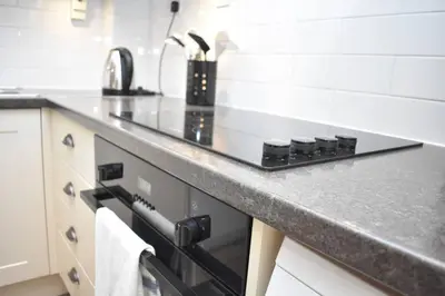 a kitchen with a stove and a counter top at West Port - 2BR in the heart of the old town just off the Grassmarket in Edinburgh