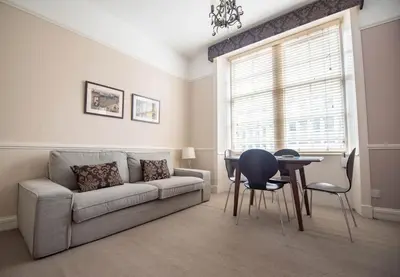 a living room with a couch and a table at West Port - 2BR in the heart of the old town just off the Grassmarket in Edinburgh
