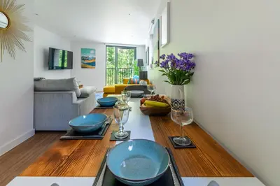 a living room with a table with blue dishes on it at Castle View Luxury 1 Bed Apartment in Edinburgh