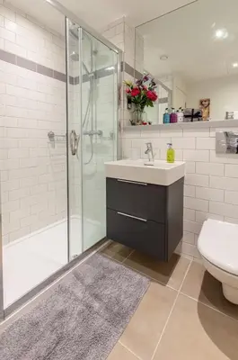 a bathroom with a shower and a sink and a toilet at Castle View Luxury 1 Bed Apartment in Edinburgh