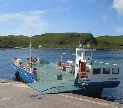 a blue and white boat sitting in the water at Number 10, Isle of Luing in Cullipool