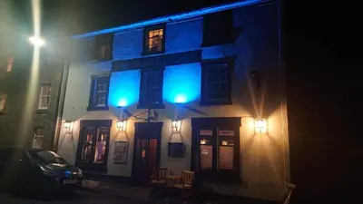 a building with blue lights on the side of it at The Dunning Hotel in Perth