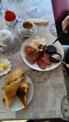 a table with two plates of breakfast food and coffee at The Dunning Hotel in Perth