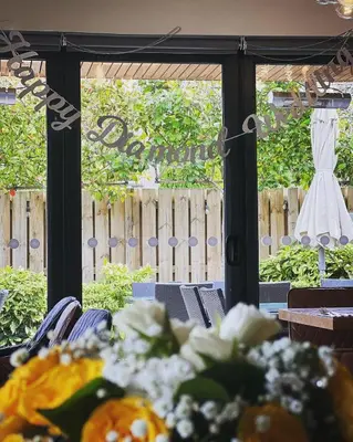 a table with pumpkins on it in front of a window at The Balerno Inn in Edinburgh