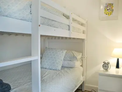 a bunk bed in a bedroom with a bunk bed in a room at Altbeg in Brodick