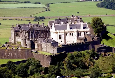 an old castle on top of a green field at Ginger's in Stirling