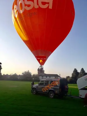 a hot air balloon flying over a field at The Old Schoolhouse, Kinross in Kinross