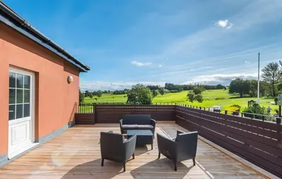 a deck with chairs and a table on a house at Signature - Greenlees Clubhouse in Glasgow