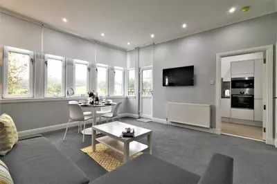 a living room with a couch and a table at Signature - Greenlees Clubhouse in Glasgow