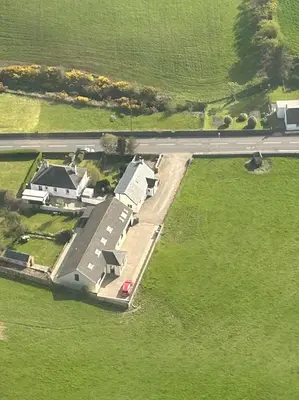 an aerial view of a house in the middle of a field at Inveroran in Campbeltown