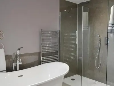 a bathroom with a shower and a toilet and a sink at Torcross Barn in Tarbolton
