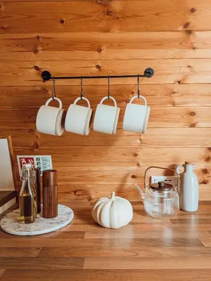a row of coffee cups hanging from a wall at Strathyre Camping Pods in Strathyre