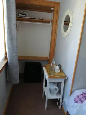 a room with a bed and a table in a room at Don Muir Guesthouse in Oban