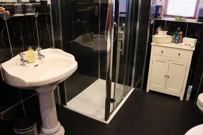 a bathroom with a sink and a glass shower at Gowanlea Heights in Campbeltown