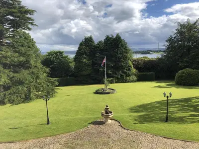a green lawn with a flag on top of it at Duneira House in Helensburgh
