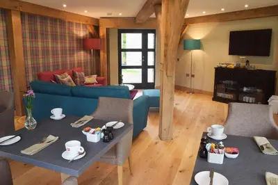 a living room with a blue couch and a table at The Loch Lomond Guesthouse in Balloch