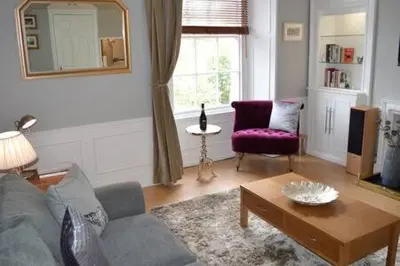 a living room with a couch and a table at castle Apartment 1 in Edinburgh