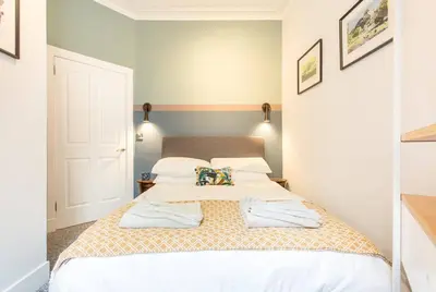 a bedroom with a bed with two pillows on it at Grassmarket Jewel in Edinburgh