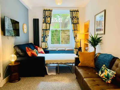 a living room with a couch and a bed at Grassmarket Jewel in Edinburgh
