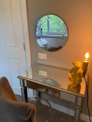 a glass table with a teddy bear on it in a room at Dunroamin Apartment in Drymen