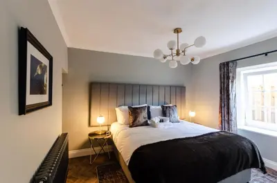 a bedroom with a large bed and a window at Sweeney Motherwell in Motherwell