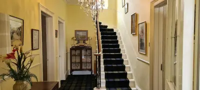 a hallway with a spiral staircase in a house at CREAG DHUBH COUNTRY HOUSE in Inveraray