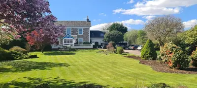 a house with a large lawn in front of it at CREAG DHUBH COUNTRY HOUSE in Inveraray
