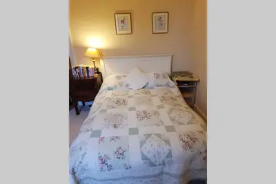a bedroom with a bed with a quilt on it at Woodburn Terrace, Morningside, Edinburgh in Edinburgh