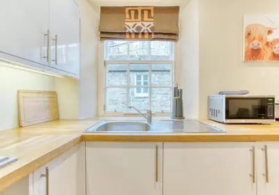 a kitchen with a sink and a microwave at The Gloucester Lane Residence in Edinburgh