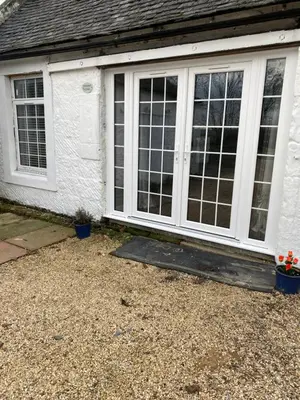 a front door of a white house with windows at COACHMAN COTTAGE OUTSIDE HOT TUB in Beith