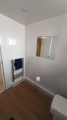 a white room with a toilet and a mirror at Carvetii - Clark House - Spacious ground floor flat in Rosyth