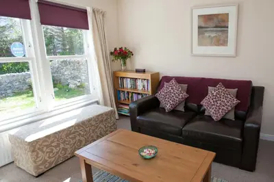 a living room with a couch and a coffee table at Killinallan Cottage in Port Charlotte