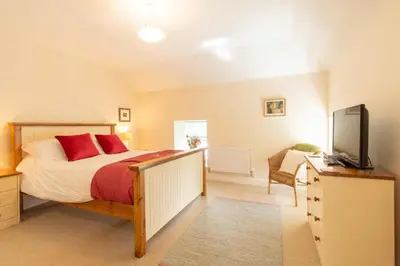 a bedroom with a bed and a flat screen tv at Saligo in Port Charlotte