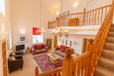 a large living room with a staircase and a living room at Saligo in Port Charlotte