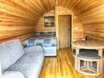 a room with a bed and a couch in a cabin at Tarbert Holiday Park in Tarbert