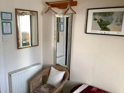 a room with a chair and a mirror at Struan House B&B in Tarbert