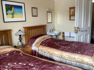a hotel room with two beds and a sink at Struan House B&B in Tarbert