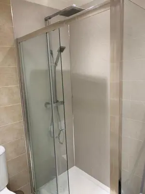 a shower with a glass door in a bathroom at Dunfermline GF flat, 5 min walk to Train St. and High St. in Dunfermline