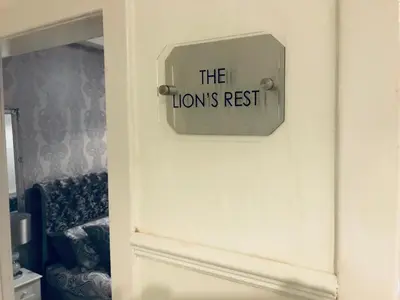 a door with a sign that reads the lions rest at THE LION’S REST - BOUTIQUE APARTMENT SUITE. in Port Glasgow