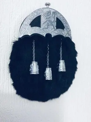 a chandelier with three bells hanging on a wall at THE LION’S REST - BOUTIQUE APARTMENT SUITE. in Port Glasgow
