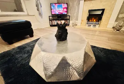 a statue in a living room with a fireplace at THE LION’S REST - BOUTIQUE APARTMENT SUITE. in Port Glasgow